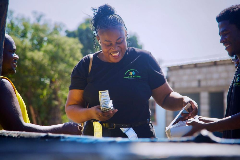 An AFF team member distributing HIV prevention commodities during community outreach