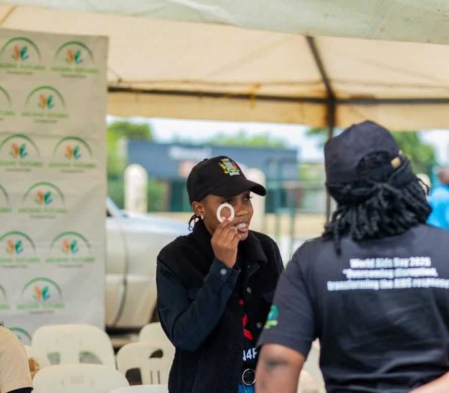 An AFF team member showing the PrEP ring during community outreach